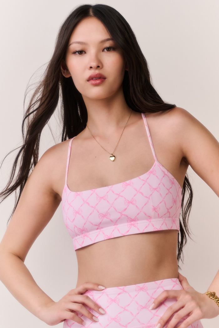 Pink sweetheart sports bra with thin straps and geometric lattice print