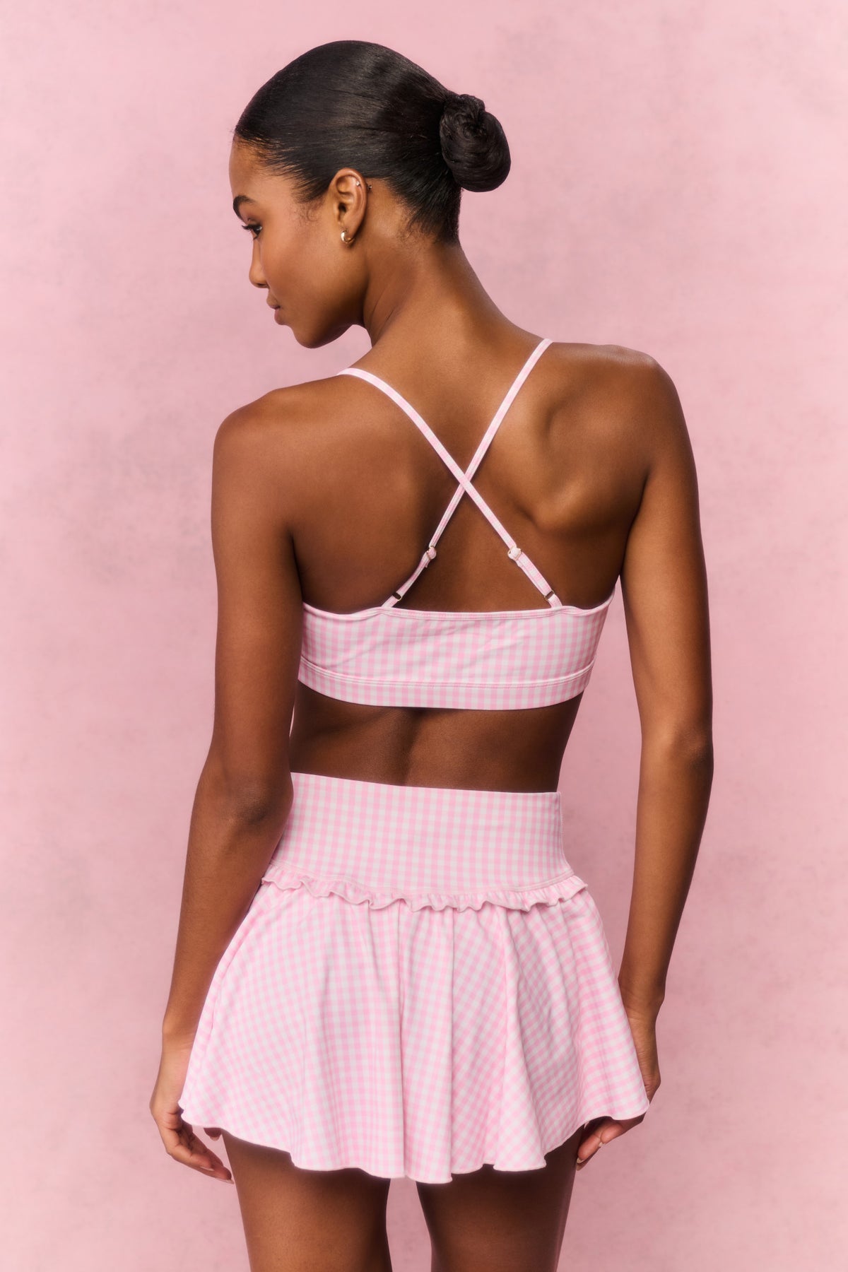 Pink gingham print active skort with tiered ruffle hem and elastic waistband