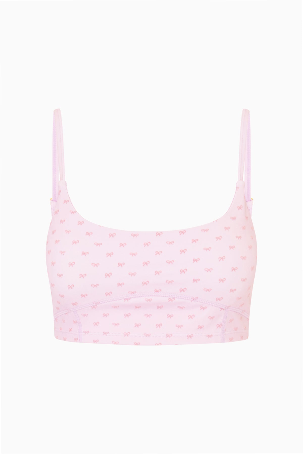 Light mauve bow-print sports bra with thin straps, flat lay