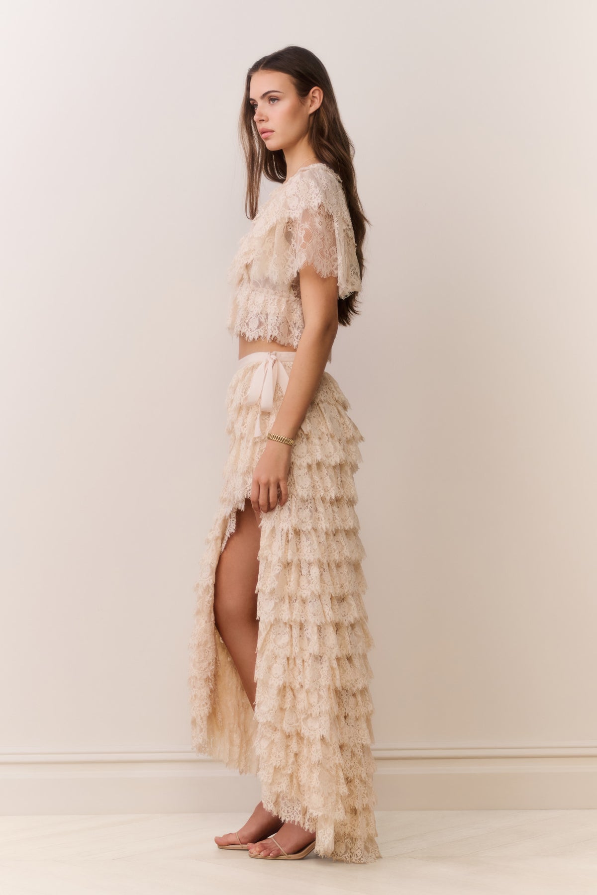 Ivory lace ruffle high-low skirt with tiered ruffle layers and long sheer texture