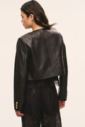 Back view of black collarless leather jacket with gold snap buttons and long sleeves