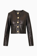 Black collarless leather jacket with gold snap buttons and front pockets, long sleeves