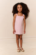 Pink sleeveless lace-trim mini dress on child, front view