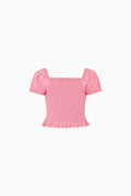 Girls’ pink smocked short-sleeve top with puff sleeves and ruffle hem