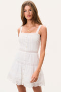 White cotton mini dress with thin straps, square neckline, button front, tiered skirt and lace hem