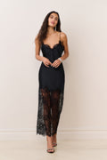 Black satin maxi slip dress with lace overlay at hem and lace-trimmed sweetheart bodice