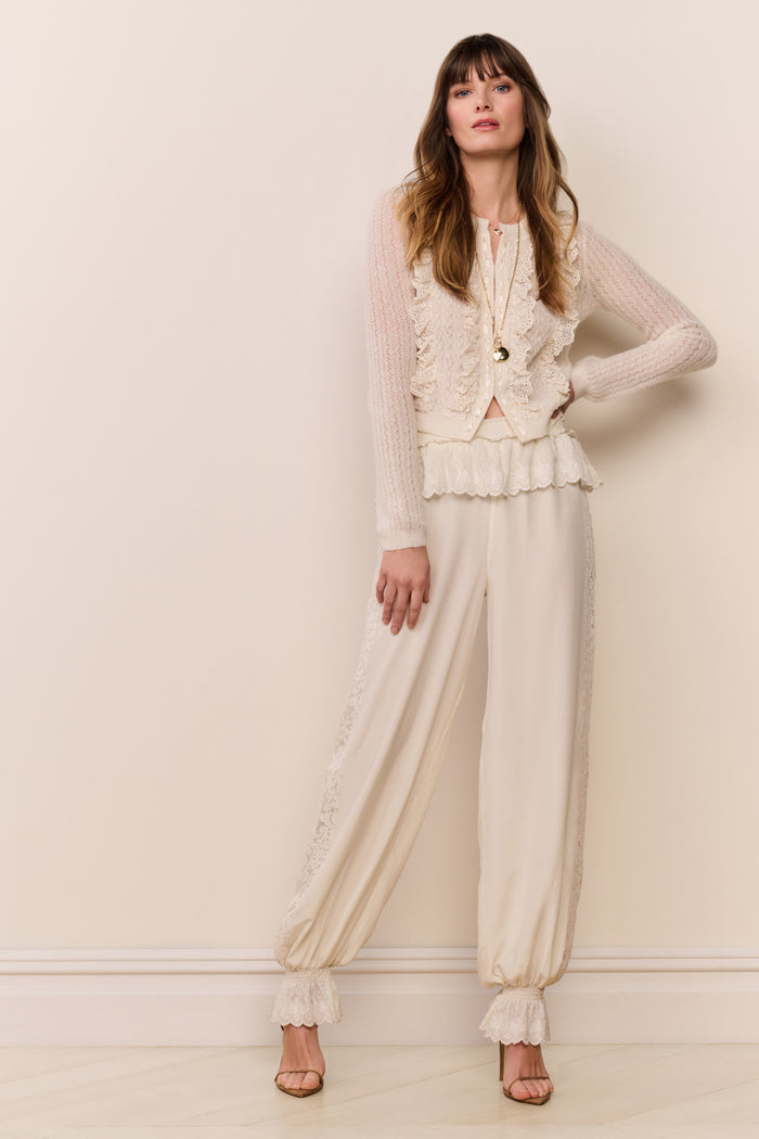Cream balloon pants with lace-trim accents and ruched elastic cuffs at the hem