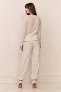 Cream balloon pants with lace trim along hems and elastic cuff ruffles
