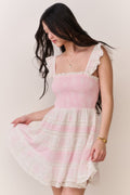 Pink mini dress with ruffled square neckline and flowing tiered skirt