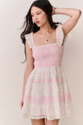 Pink sleeveless mini dress with ruffled square neckline and tiered hem