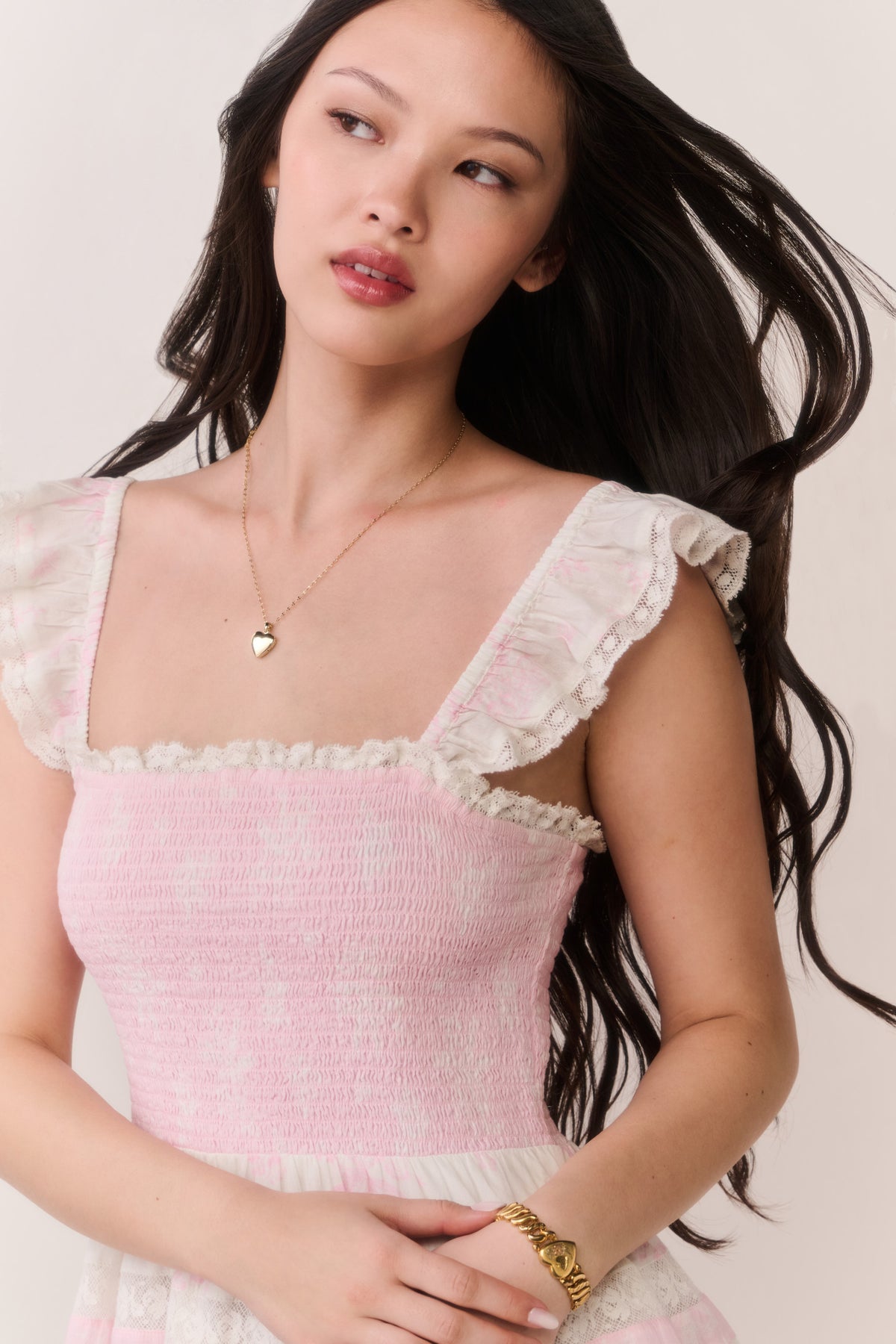 Pink mini cotton dress with ruffled square neckline and cap sleeves, tiered skirt