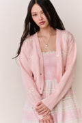 Petal pink cardigan with bow embroidery, V-neckline, and button front