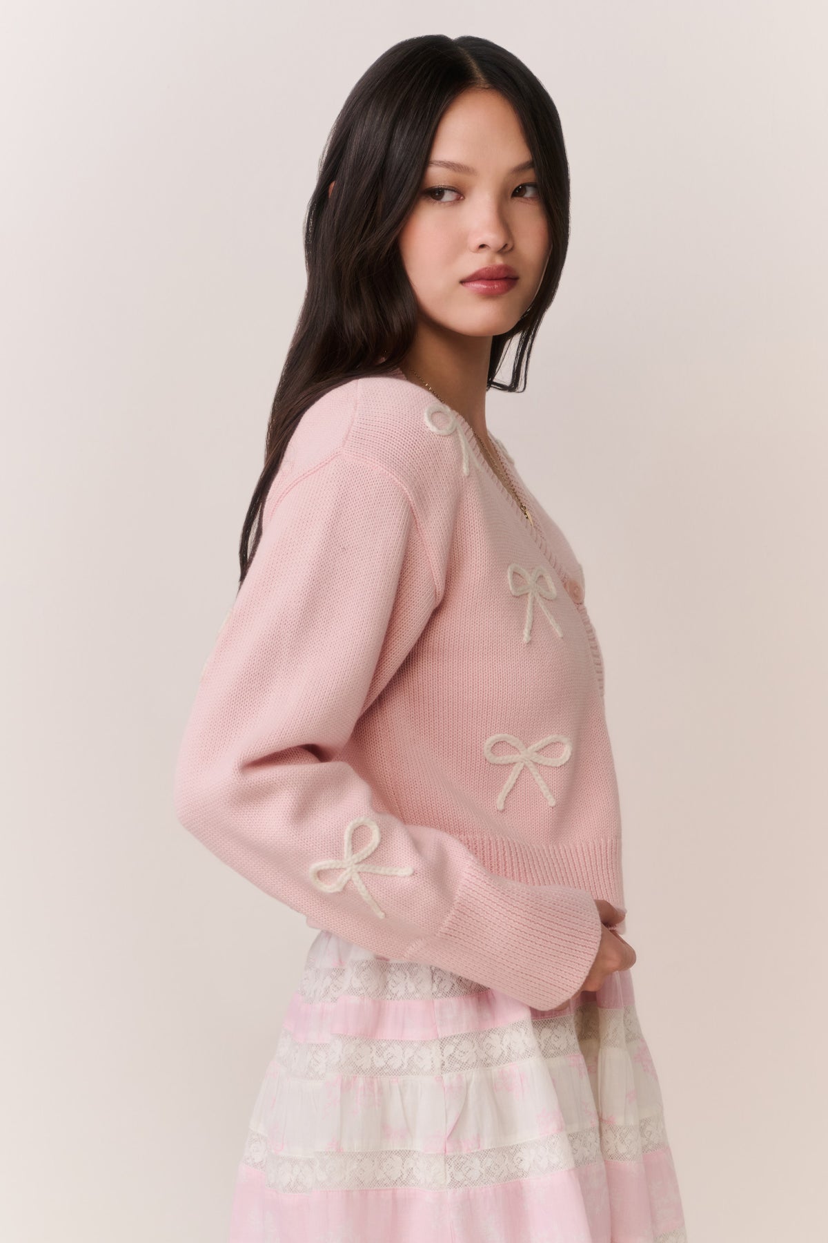 Petal pink cardigan with bow embroidery on sleeves and ribbed cuffs