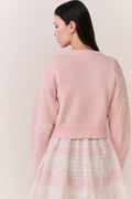 Petal pink cardigan back view with bow embroidery on the right sleeve