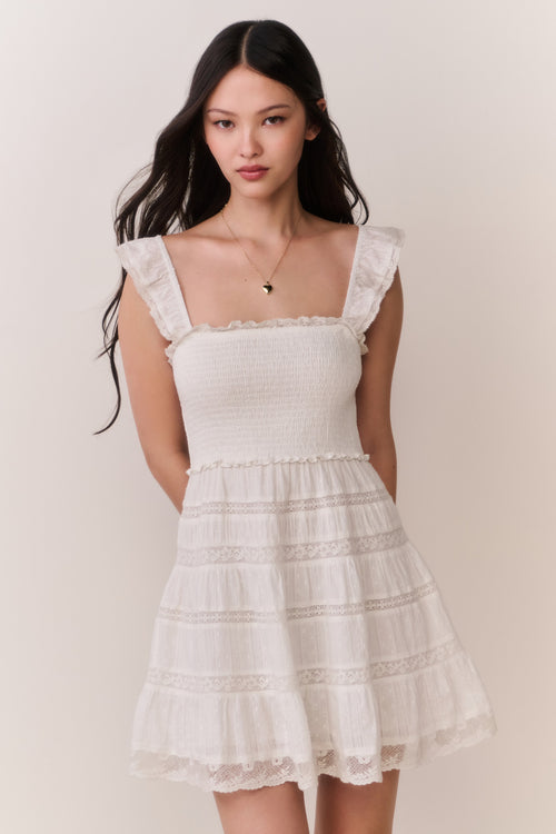 Front-view lace-trimmed cotton mini dress with smocked bodice and tiered skirt