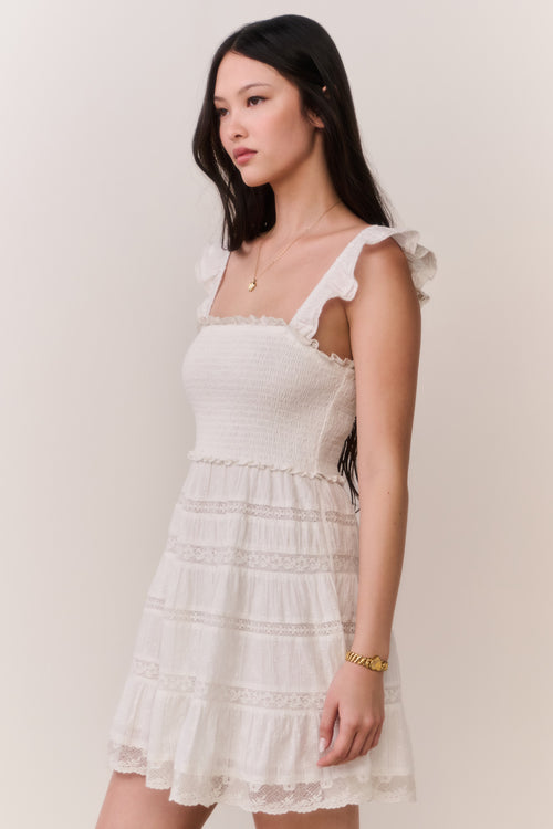 Side-view lace-trimmed cotton mini dress in pale white, square neck, ruffle straps
