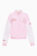 Light pink snap-front varsity jacket with red-outlined patches and striped cuffs.