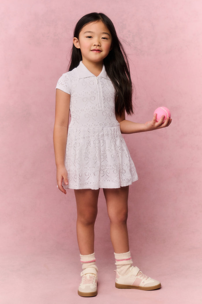 White eyelet dress with collar, short sleeves, and flared skirt for movement