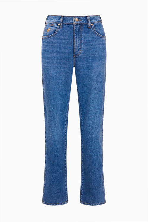 Medium wash cowboy cut jeans laid flat with button closure and flared leg