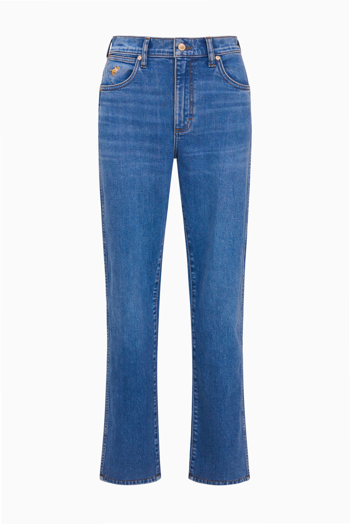 Medium wash cowboy cut jeans laid flat with button closure and flared leg