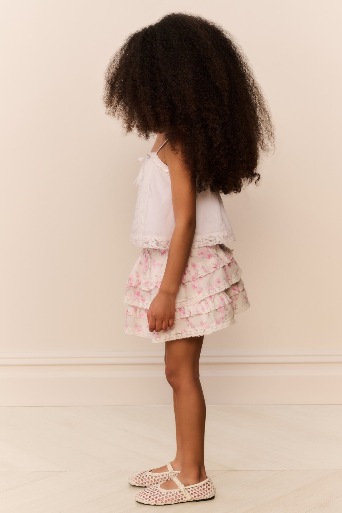 Girls floral tiered skirt with layered ruffles and elastic waistband, pink/white (side view)