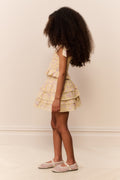 Girls light-yellow floral tiered ruffle top with bow shoulder ties, side view