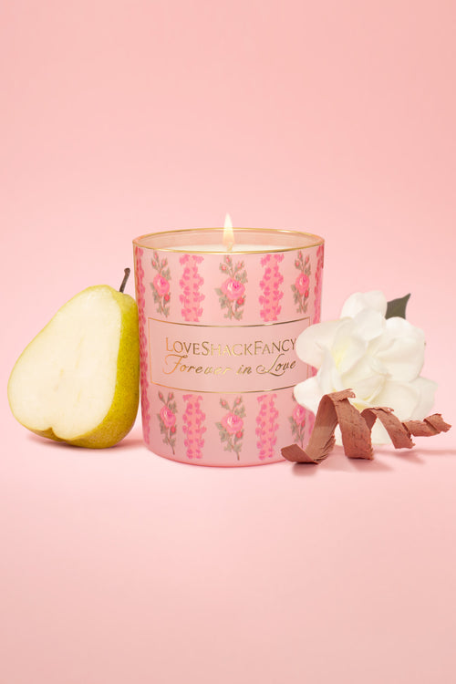 LoveShackFancy pink floral candle with flame, pear and flower accents