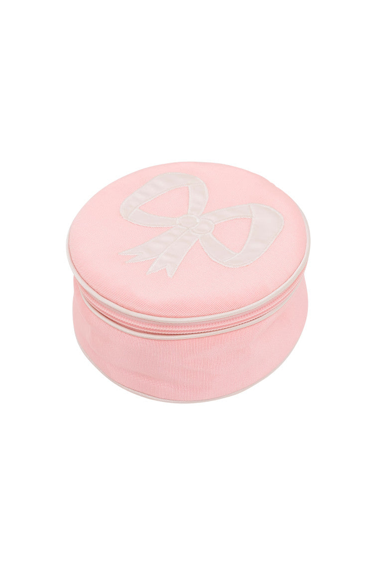Round zip jewelry case in dusty rose pink with bow detail on the lid