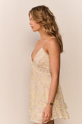 Floral mini dress in light yellow with spaghetti straps and tiered ruffle skirt