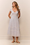 Light blue midi dress with V-neck, short puff sleeves, and embroidered stripe tiers