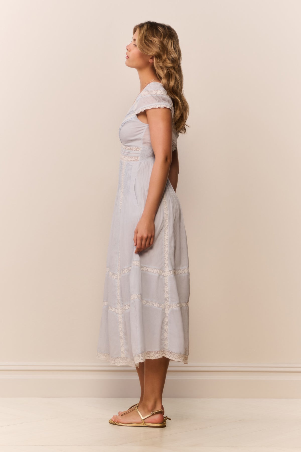 Light blue midi dress from side view with V-neck and tiered embroidered panels