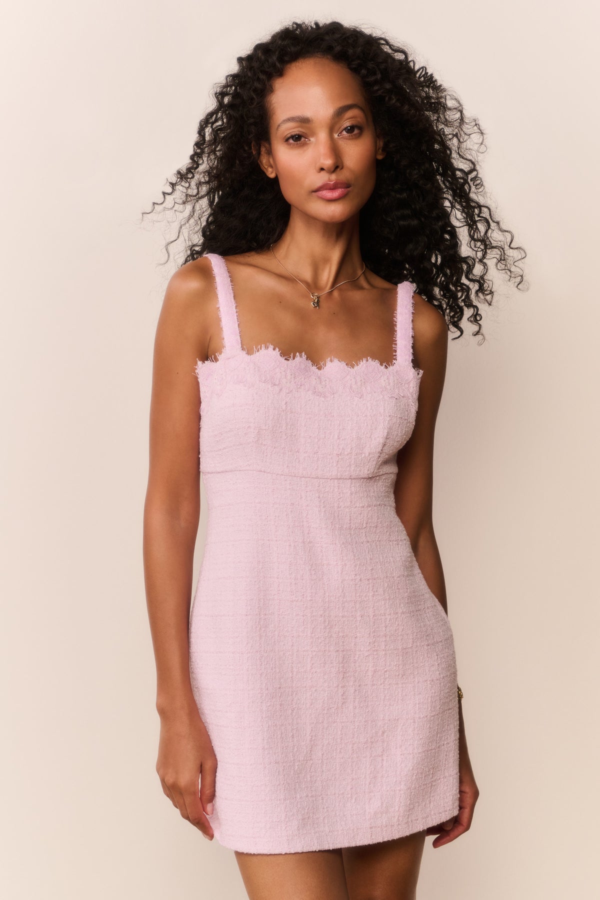 Blush lace-trim tweed mini dress with spaghetti straps and fitted mini hem.