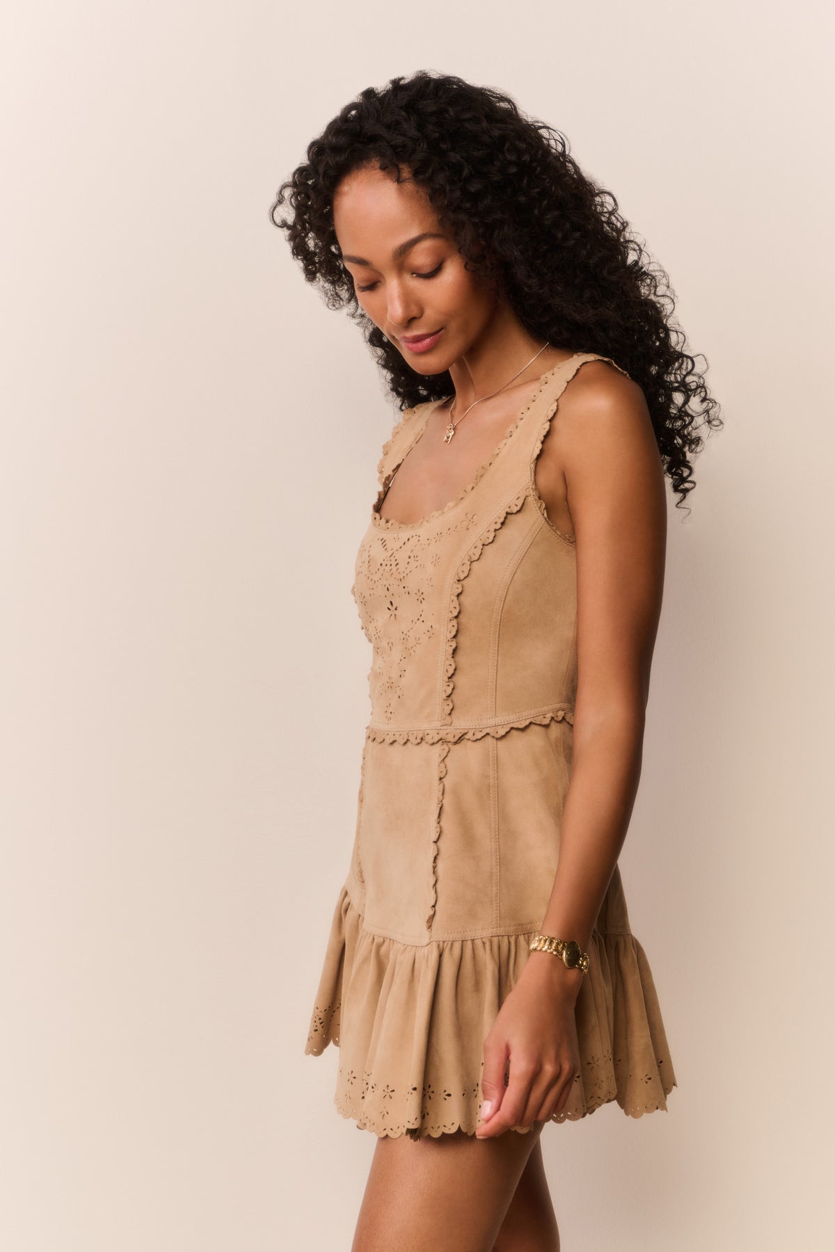 Tan suede eyelet mini dress side view with tiered ruffle skirt and lace details