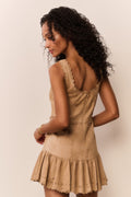 Tan suede eyelet mini dress from the back with open back yoke and tiered hem