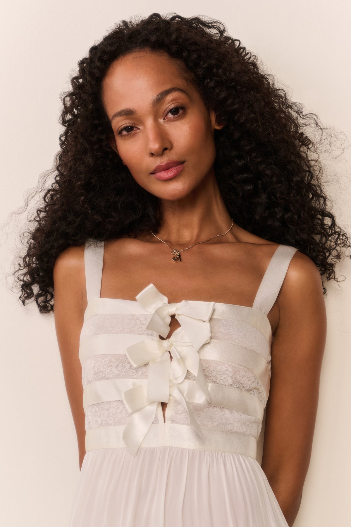 Cream sheer maxi dress close-up of layered bow and banded waist