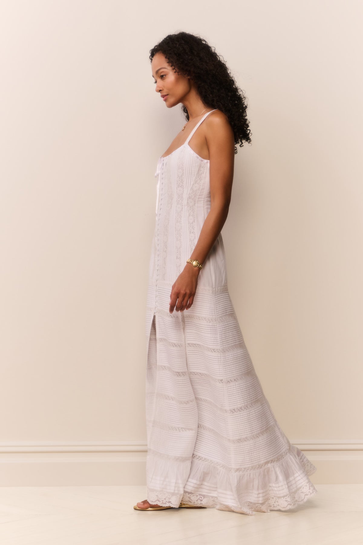 White cotton Victorian maxi dress side view with lace paneling and tiered ruffle hem