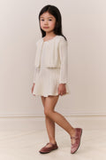 Girls cream pointelle knit cardigan with front buttons and scalloped edges