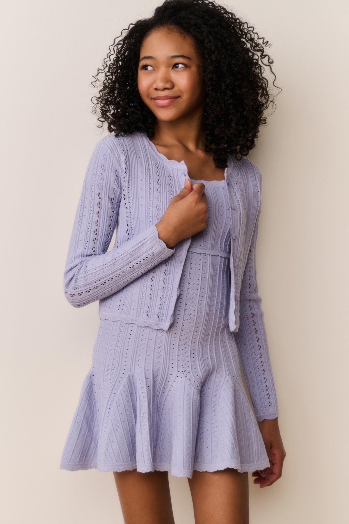 Lavender pointelle cardigan with long sleeves and open front, vertical stitch pattern.