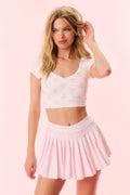 Pink printed active skort in pleated silhouette with elastic waist gather