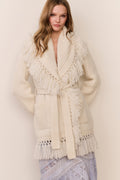 Ivory wrap cardigan with fringe hem and cuffs, tied front, ribbed knit texture.