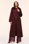 Long dark merlot wool coat with faux fur collar, button front, and waist tie belt.