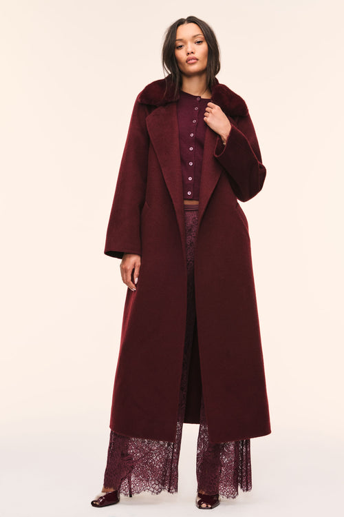 Long dark merlot wool coat with faux fur collar, button front, and waist tie belt.
