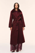 Dark merlot long wool coat with faux fur collar and waist tie belt, worn with lace hem.