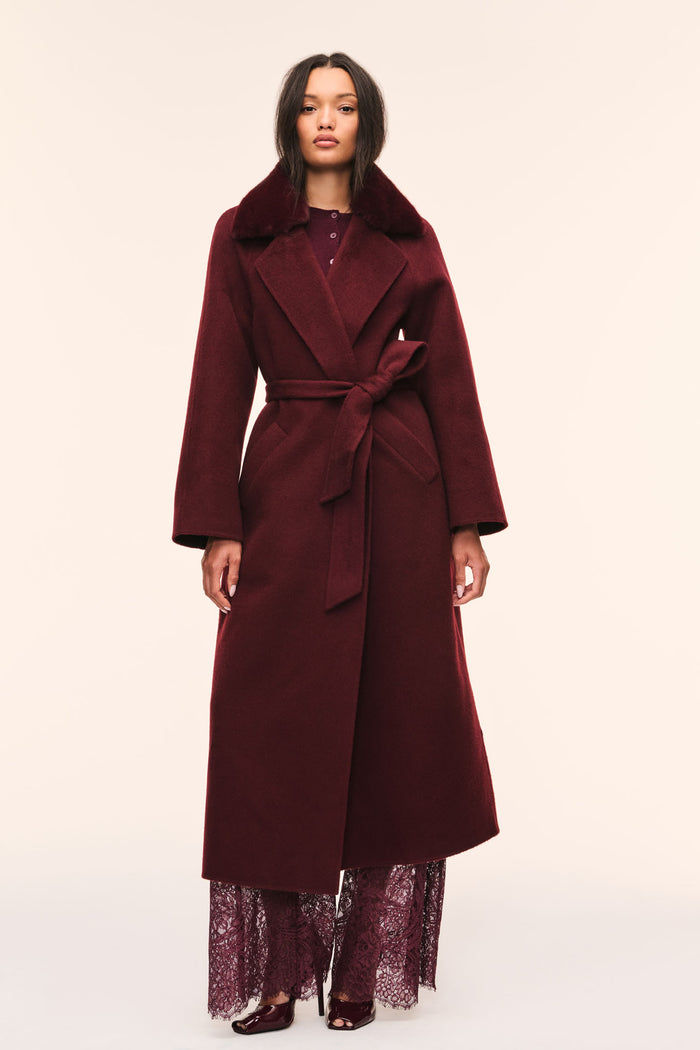 Dark merlot long wool coat with faux fur collar and waist tie belt, worn with lace hem.