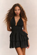 Black halter mini dress with tiered ruffle skirt and scalloped hem