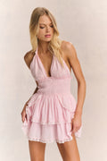 Pink halter ruffle mini dress with adjustable straps and layered skirt tiers