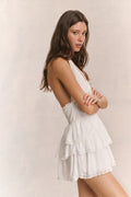 White halter ruffle mini dress with tiered skirt and lace-trim edges