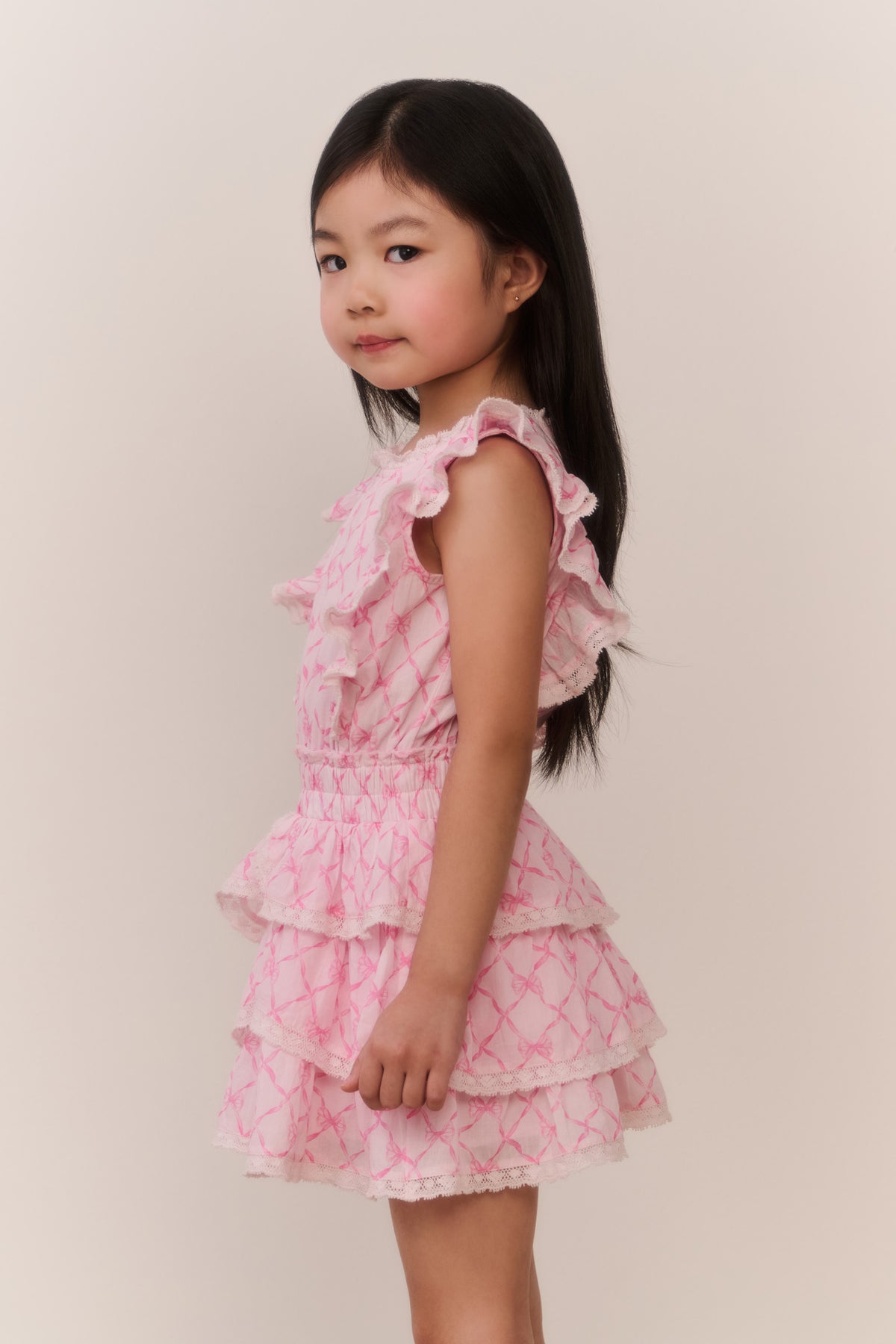 Pink tiered ruffle mini dress with diamond texture and flutter sleeves