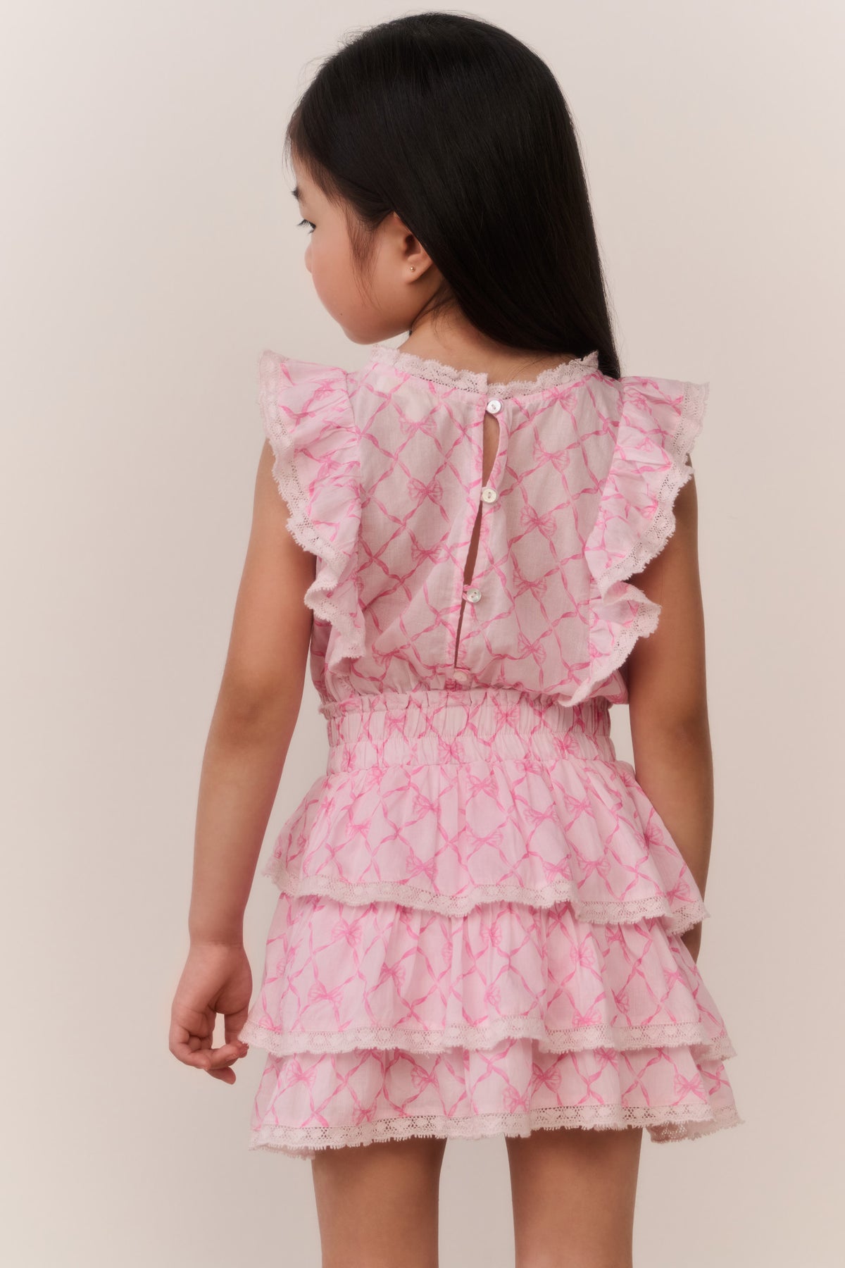 Pink tiered ruffle mini dress with cap sleeves and button back detail