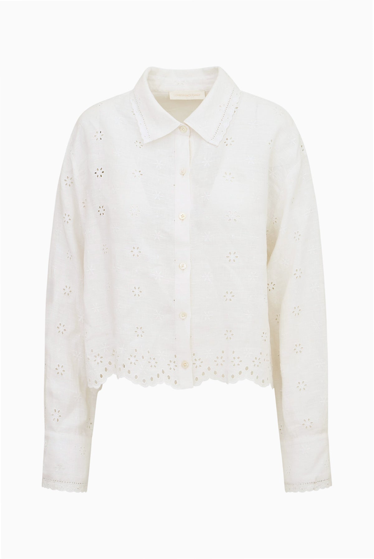 White linen button-up shirt top with eyelet embroidery, point collar, front buttons.